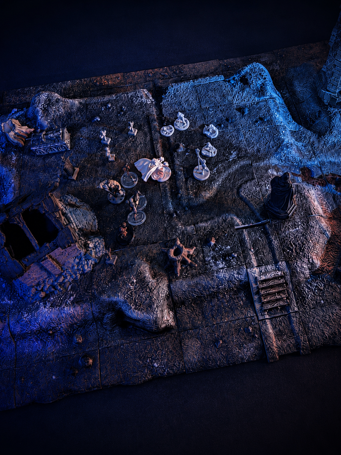 Dramatic dungeon encounter with miniatures and projected lighting on the tabletop