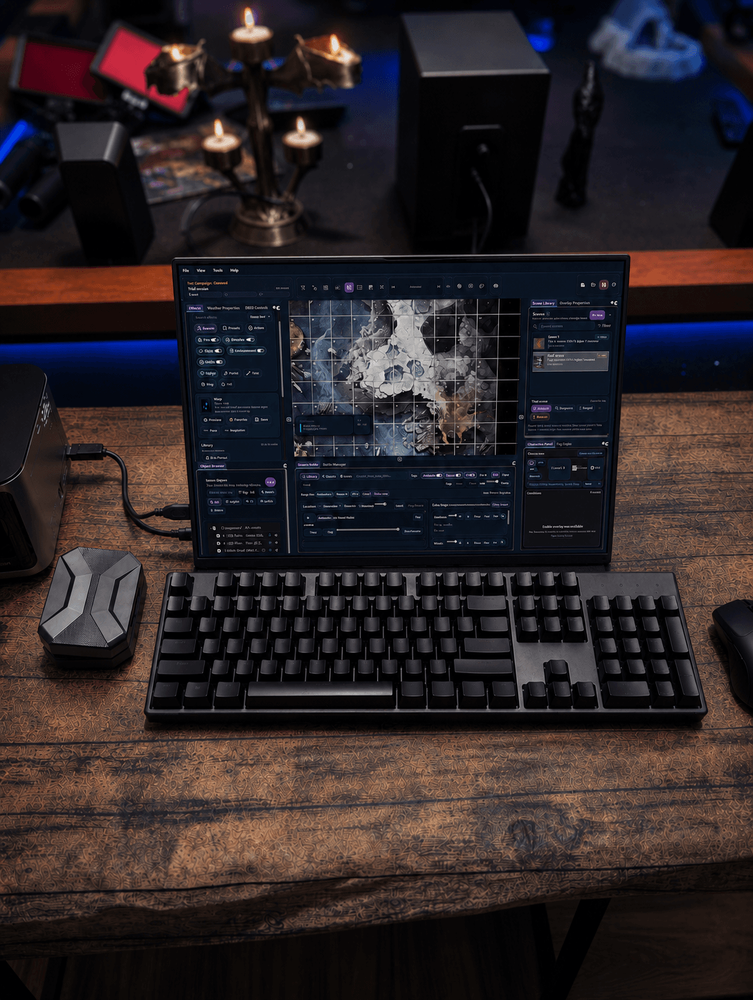 Laptop displaying the TabletopFX Game Master interface with a grid-aligned battlefield preview.