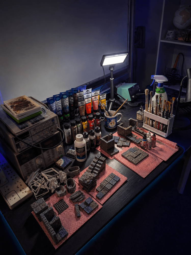 Early Evernight Realms workshop with 3D printers, tools, books and terrain-making equipment.